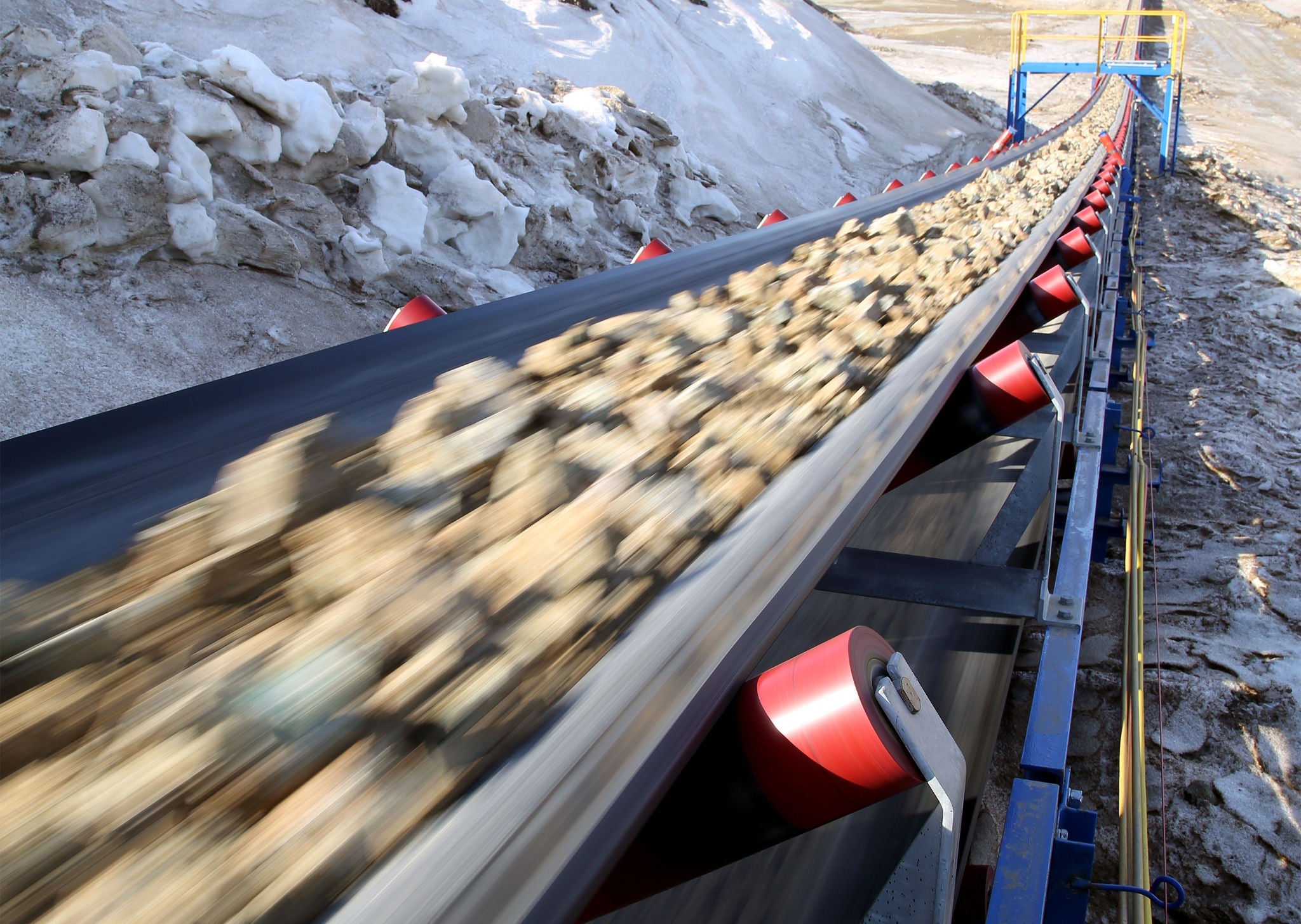 IN_QM_Conveyor-Belt_Shutterstock_1549596065.jpg Conveyor belt moves ore from the quarry for processing. Blurred foreground