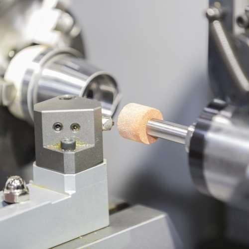 Machine tools, grinding process operator grinding mold and die part by universal grining machine