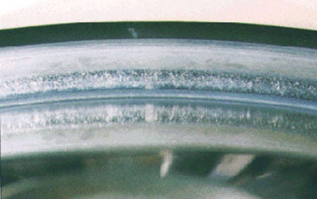 Linear damage (scoring) on large rib face of SRB inner ring.